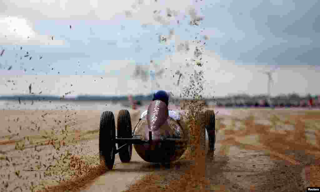 A motoring enthusiast takes part in the 'Race The Waves' classic car and motorcycle meet at the beach in Bridlington, Britain.