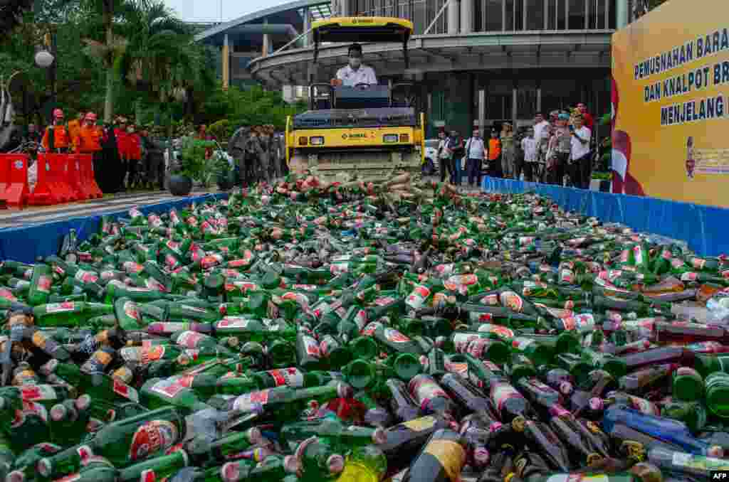Thousands alcohol bottles are destroyed in Pekanbaru, Indonesia, ahead of the Muslim holy month of Ramadan.