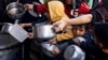 ARCHIVO - Niños palestinos esperan para recibir comida elaborada por una cocina de caridad en medio de la escasez de suministros de alimentos en Rafah, en el sur de la Franja de Gaza, el 5 de marzo de 2024.