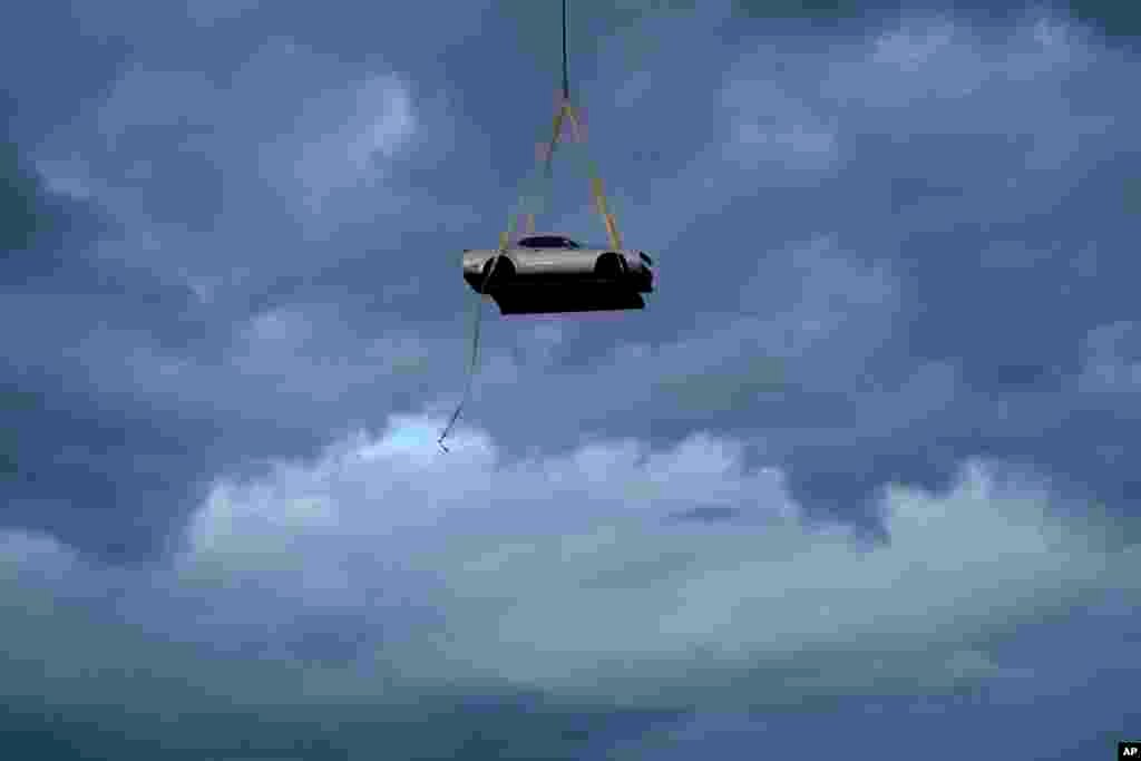 A helicopter transports the 2023 Challenger SRT Demon 170 during an event to unveil the car, March 20, 2023, in Las Vegas.