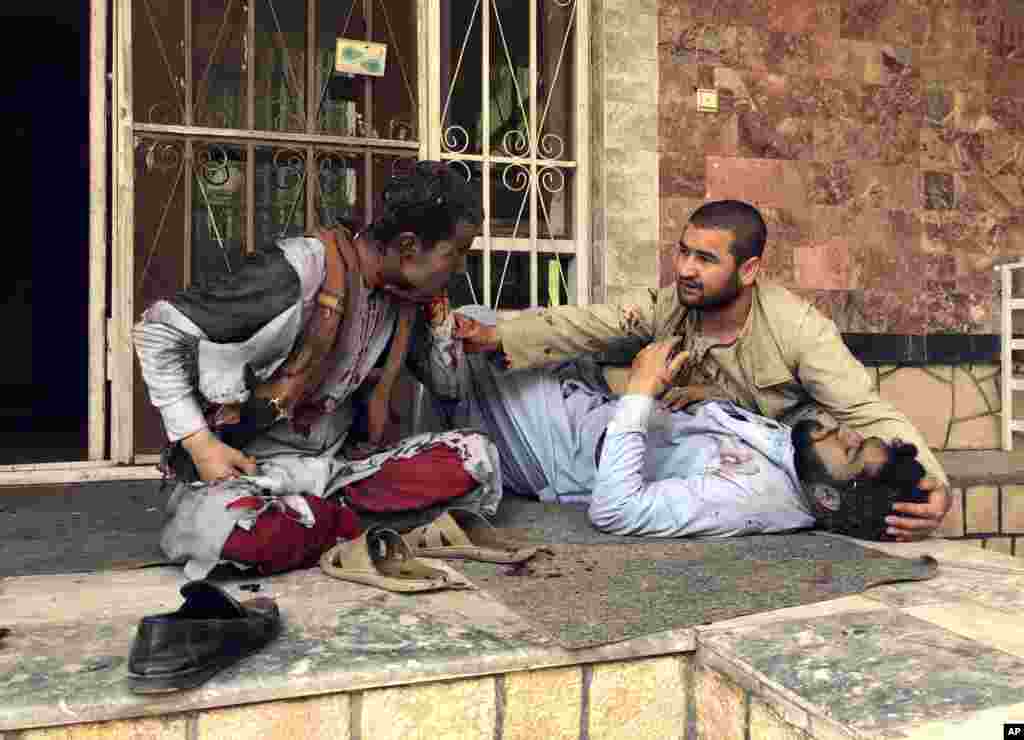 An injured man lies down after a bomb blast in Mazar-e-Sharif, the capital city of Balkh province, in northern Afghanistan, March 11, 2023. A bomb exploded during an award ceremony for journalists in the city.