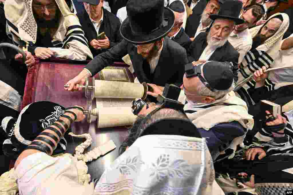 Hasidic Jewish pilgrims pray with the Torah in the former house of late miracle rabbi Yeshaya Steiner, also known as Rebbe Shaya'le, in the village of Bodrogkeresztur, Hungary, April 24, 2023, during a pilgrimage of Hasidic Jews on the occasion of Rabbi Steiner's 98th death anniversary.