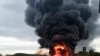 In this image released by Sirena telegram channel on Aug. 20, 2023, a Russian warplane is burning on the Soltsy air base in the Novgorod region in northwestern Russia. 