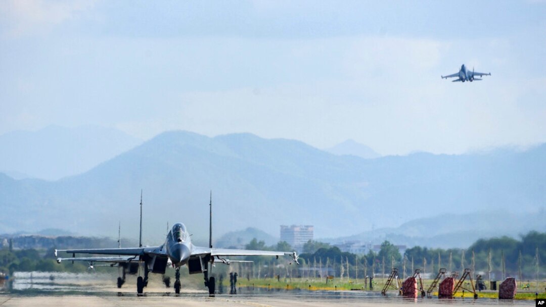 FILE - In this photo released by China's Xinhua News Agency, air force and naval aviation corps of the Eastern Theater Command of the Chinese People's Liberation Army (PLA) fly planes at an unspecified location in China, Aug. 4, 2022. 