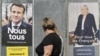 Peatones pasan frente a carteles de campaña del presidente francés y el candidato a la reelección Emmanuel Macron (izquierda) y la candidata presidencial de la extrema derecha Marine Le Pen en Eguisheim, este de Francia, el 21 de abril de 2022.