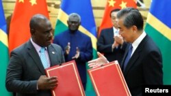 资料照：中国国务委员兼外交部长王毅与所罗门群岛外长马内莱2019年10月9日在中国北京人民大会堂出席一个签字仪式。（路透社）
