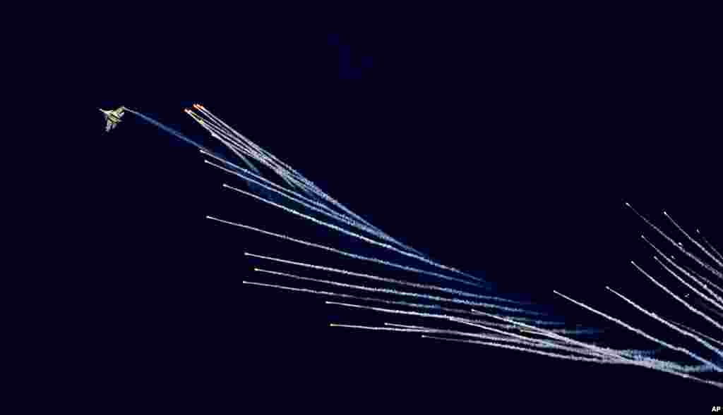 An Indian Air Force fighter aircraft Sukhoi Su-30 fires flares during Air Force Day parade at Hindon Air Force Station on the outskirts of New Delhi.