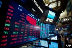 A TV screen shows the numbers after the closing bell at the New York Stock Exchange (NYSE) on August 14, 2019 in New York City.