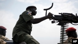 A government soldier mans a vehicle-mounted machine gun in the oil-rich town of Malakal, South Sudan.