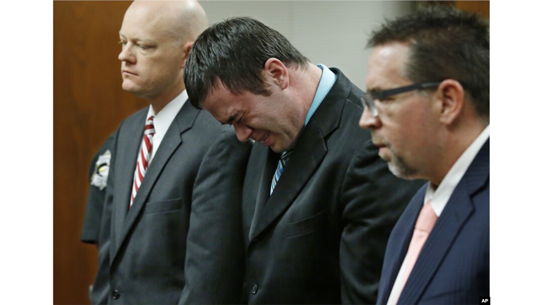Daniel Holtzclaw, center, cries as he stands in front of the judge after the verdicts were read in his trial in Oklahoma City, Dec. 10, 2015.