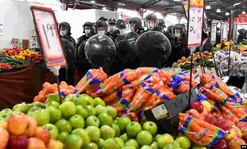 Riot police clear Melbourne's Queen Victoria Market of anti-lockdown protesters during a rally on amid the COVID-19 pandemic.