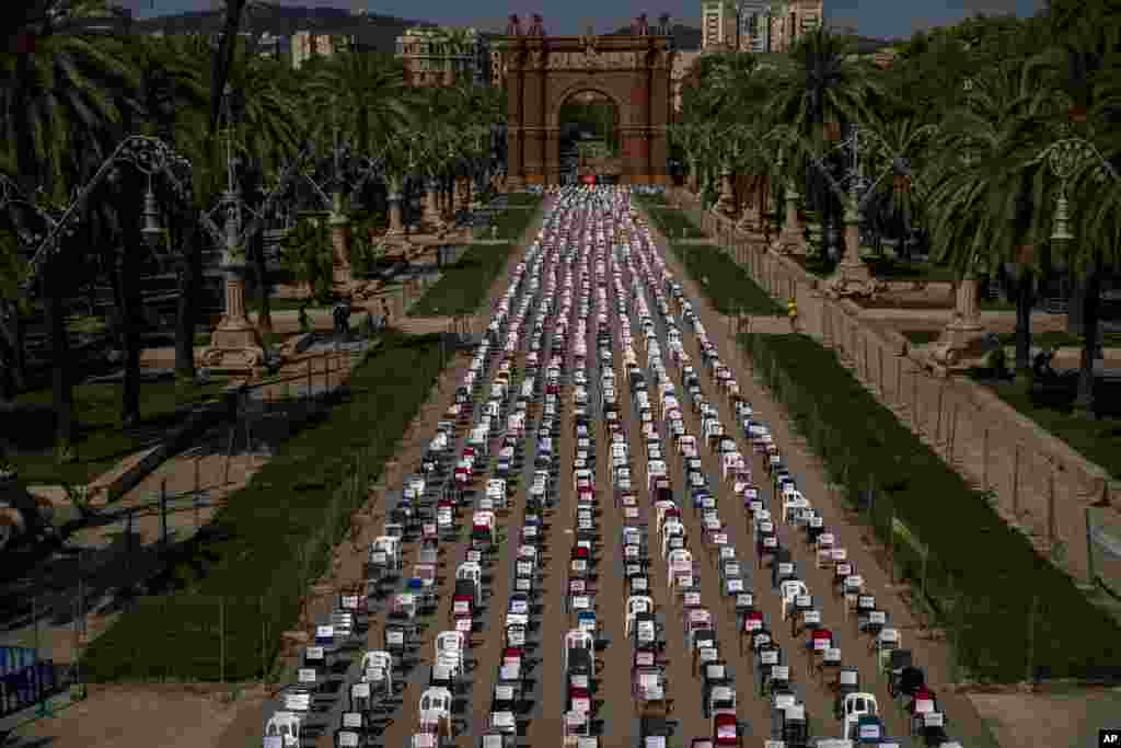 Empty chairs with the names of activists are seen placed on a boulevard with the triumphal arch at the background, during a symbolic event marking Catalan National Day in Barcelona, Spain.