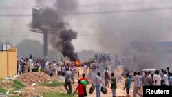 People take part in protests over fuel subsidy cuts in Khartoum September 25, 2013.