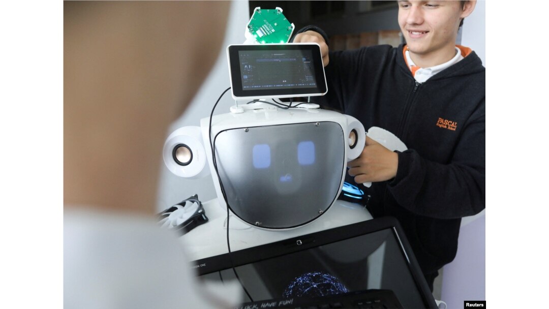 High school students Konstantinos Timinis and Vladimir Baranov work on "Alnstein", a robot powered by ChatGPT, in Pascal school in Nicosia, Cyprus on March 30, 2023. (REUTERS/Yiannis Kourtoglou)