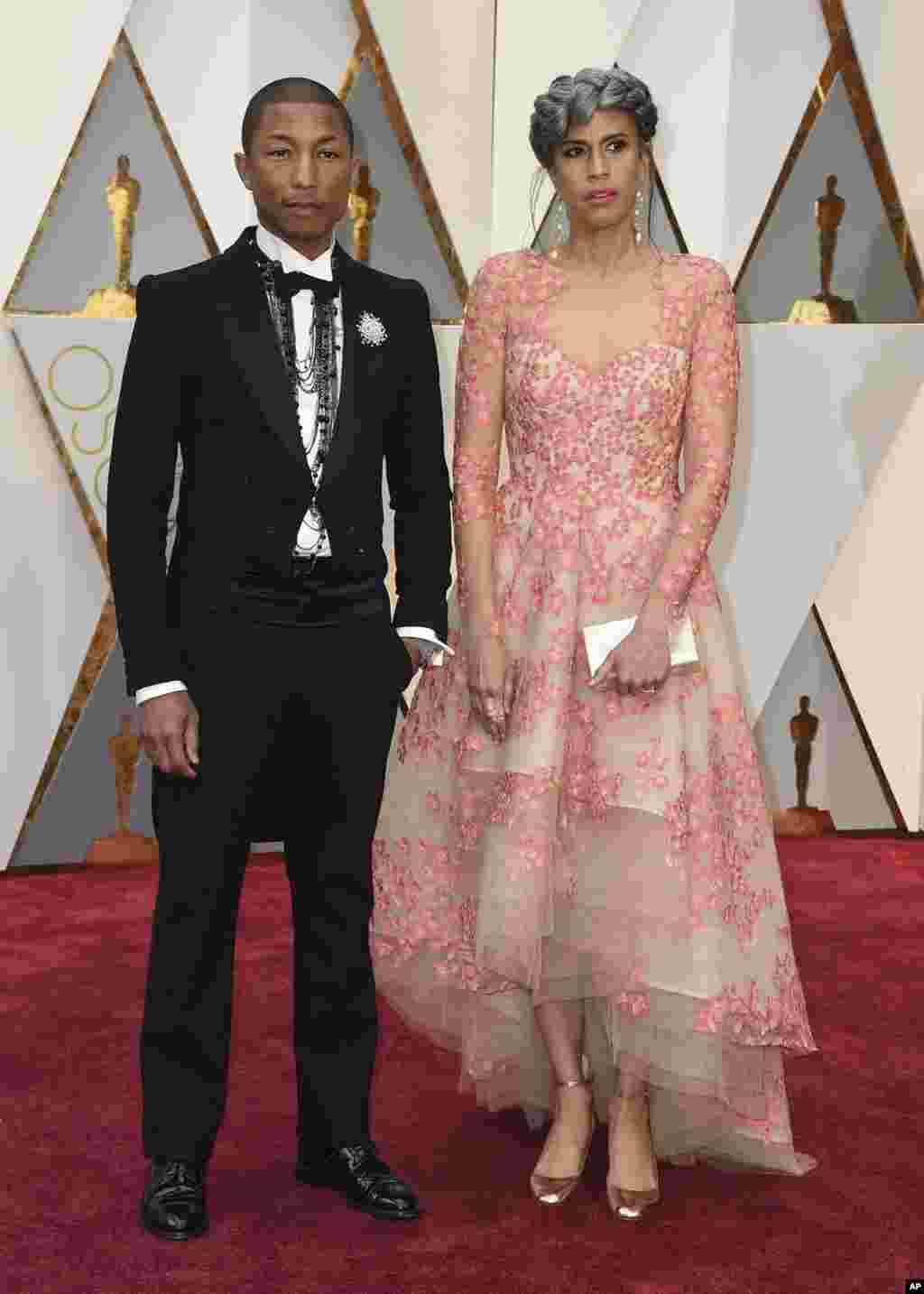 Pharrell Williams, left, and Mimi Valdes arrive at the Oscars on Feb. 26, 2017, at the Dolby Theatre in Los Angeles.