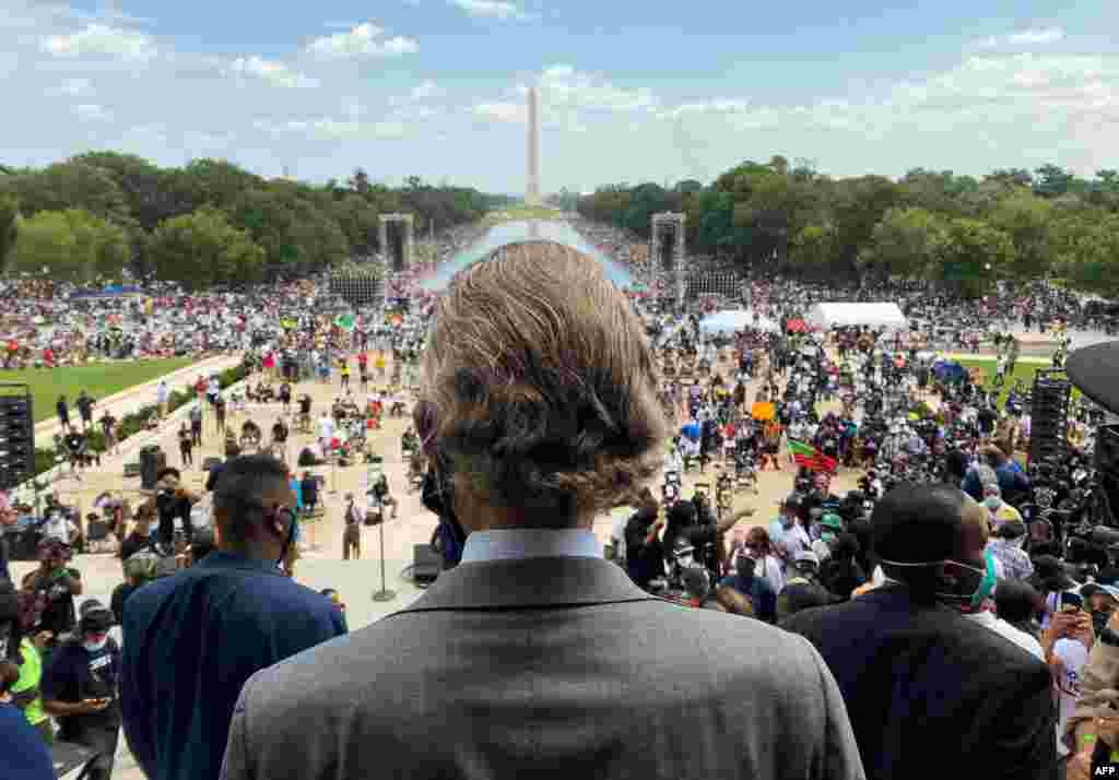Rev. Al Sharpton, center, whose National Action Network organized the "Commitment March: Get Your Knee Off Our Necks" protest against racism and police brutality, arrives at the Lincoln Memorial in Washington, D.C.