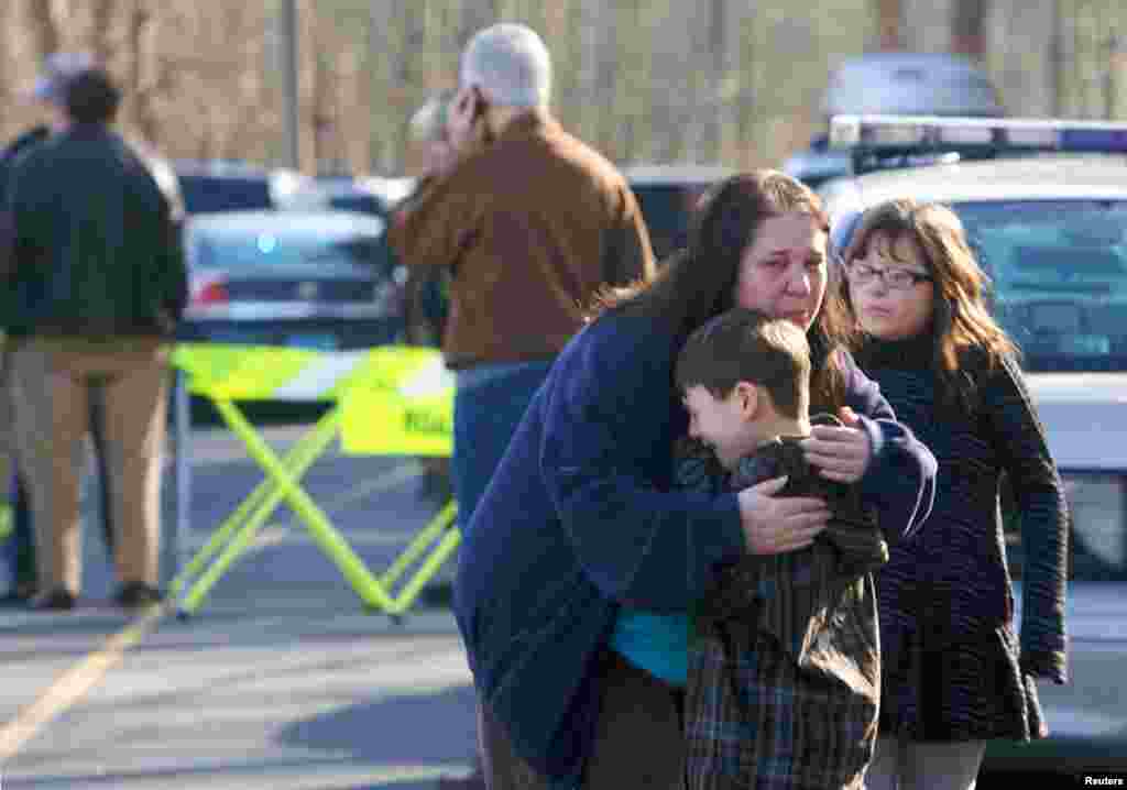 Một cậu bé được an ủi bên ngoài trường tiểu học Sandy Hook, nơi xảy ra vụ nổ súng.