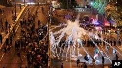 Pro-democracy demonstrators defied tear gas and appeals from Hong Kong's top leader to go home. The protest came after China's decision to limit political reforms.