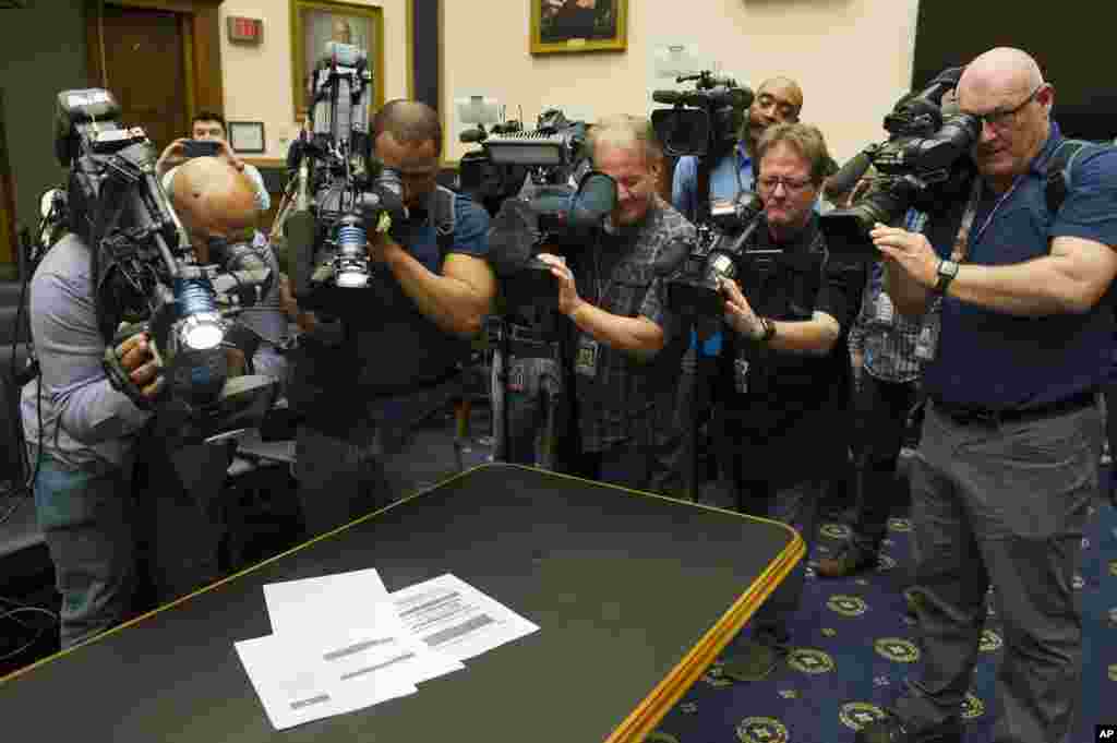 Photojournalists photograph four pages of the Mueller Report laid on the witness table in the House Intelligence Committee hearing room on Capitol Hill. The redacted version of Special counsel Robert Mueller&#39;s 400-page report on his investigation into Russian meddling in the 2016 U.S. election is released by Attorney General William Barr.