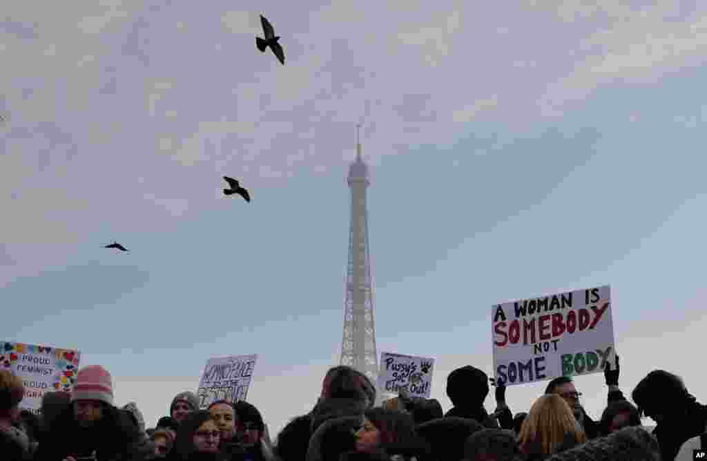 Protesters take part in a Women's March next to the Eiffel Tower, in Paris, France, Saturday, Jan. 21, 2017. The march is part of a worldwide day of actions following the inauguration of U.S President Donald Trump. (AP Photo/Christophe Ena)