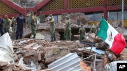 Soldiers remove debris from a partly collapsed municipal building felled by a massive earthquake in Juchitan, Oaxaca state, Mexico, Friday, Sept. 8, 2017. One of the most powerful earthquakes ever to strike Mexico has hit off its southern Pacific coast, k