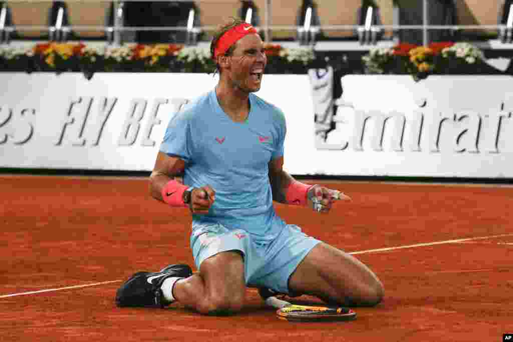 Spain's Rafael Nadal celebrates winning the final match of the French Open tennis tournament against Serbia's Novak Djokovic in three sets, 6-0, 6-2, 7-5, at the Roland Garros stadium in Paris, France.