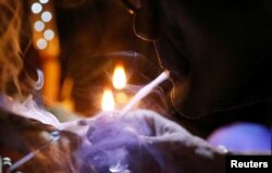 A drug user inhales "shabu," or methamphetamine, at a drug den in Manila, Philippines, Feb. 13, 2017.