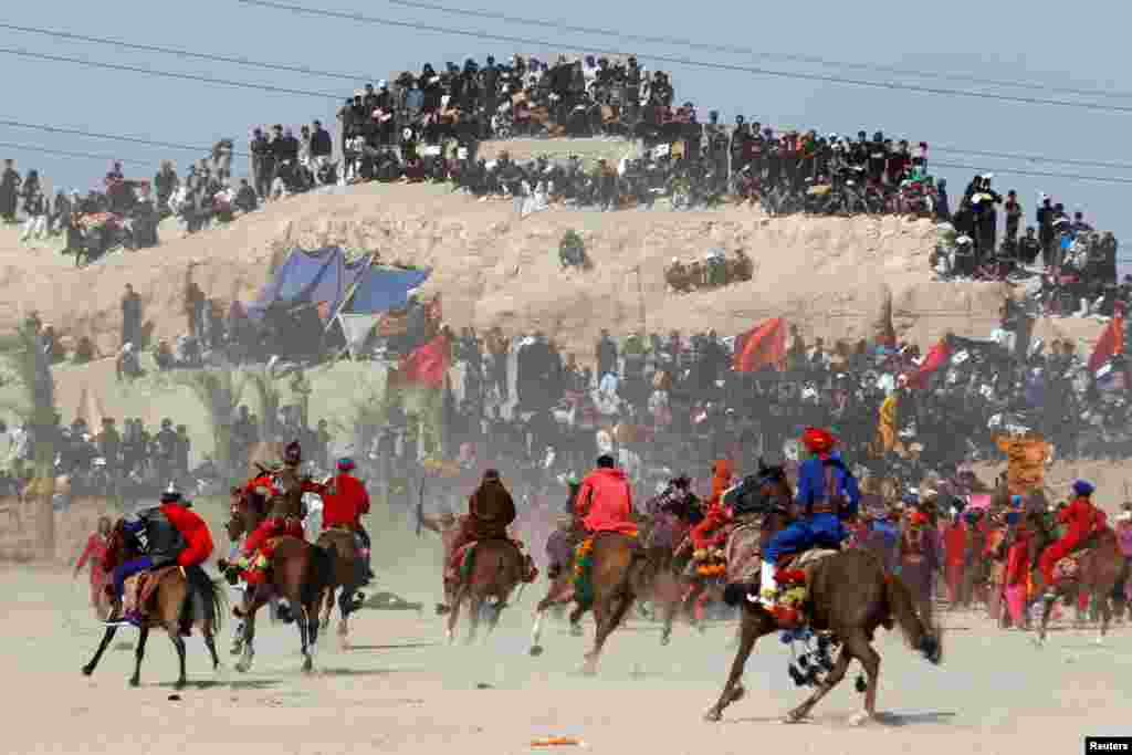Iraqi Shi'ite Muslims re-enact a scene from the 7th century battle of Karbala to commemorate Ashura, the holiest day on the Shi'ite Muslim calendar in the holy city of Najaf.