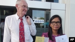 Biên tập viên người Úc Alan Morison, và bà Chutima Sidasathan, phóng viên của trang tin tức mạng có trụ sở ở Phuket, rời tòa án ở Phuket