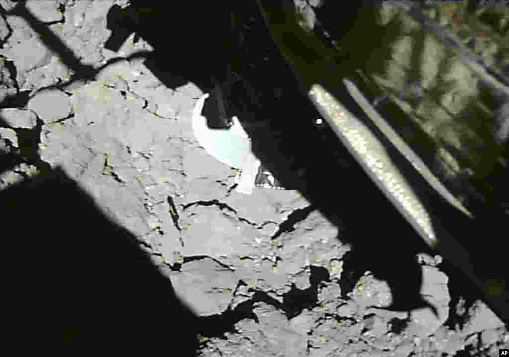 This photo was taken and released on Thursday, July 11, 2019, by the Japan Aerospace Exploration Agency, the Japanese Hayabusa2 spacecraft lands on an asteroid to collect samples.