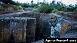 Umurwanyi wa TPLF ahagaze ahari isengero ry'umweranda Saint George i Lalibela, muri Etiyopiya, Kw'itariki 07/12/2021