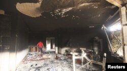 A man walks inside the U.S. consulate in Benghazi, which was attacked September 11, 2012.