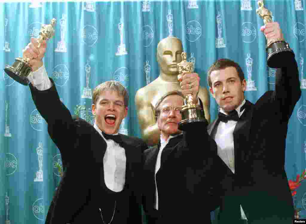 Oscar winners (left to right) Matt Damon, Robin Williams and Ben Affleck hold their Oscars for their work on the film "Good Will Hunting" at the 70th Annual Academy Awards, March 23, 1998, in Los Angeles. Damon and Affleck won for Best Screenplay Written Directly for the Screen and Williams won for Best Supporting Actor.