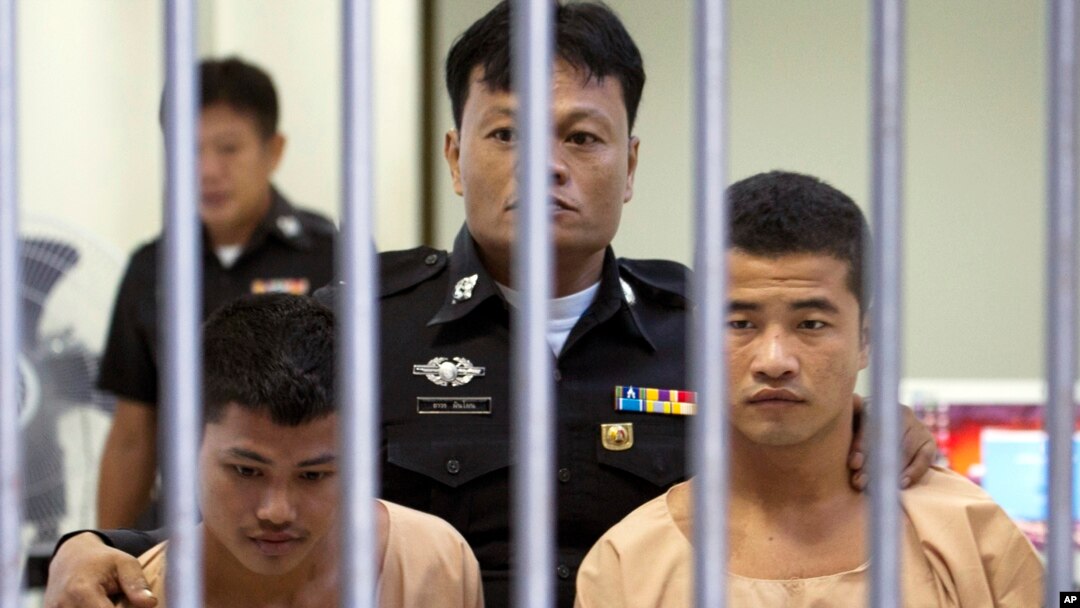 Myanmar migrants Win Zaw Htun, right, and Zaw Lin, left, both 22, are escorted by officials after their guilty verdict at court in Koh Samui, Thailand, Thursday, Dec. 24, 2015.