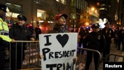 A supporter of President-elect Donald Trump shouts back at opposing demonstrators during a protest against the president-elect in Manhattan, New York, Nov. 11, 2016.