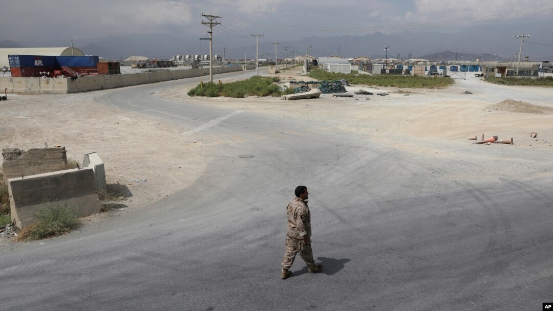 A member of the Afghan security forces walks in the sprawling Bagram air base after the American military departed, in Parwan province north of Kabul, Afghanistan, July 5, 2021. 