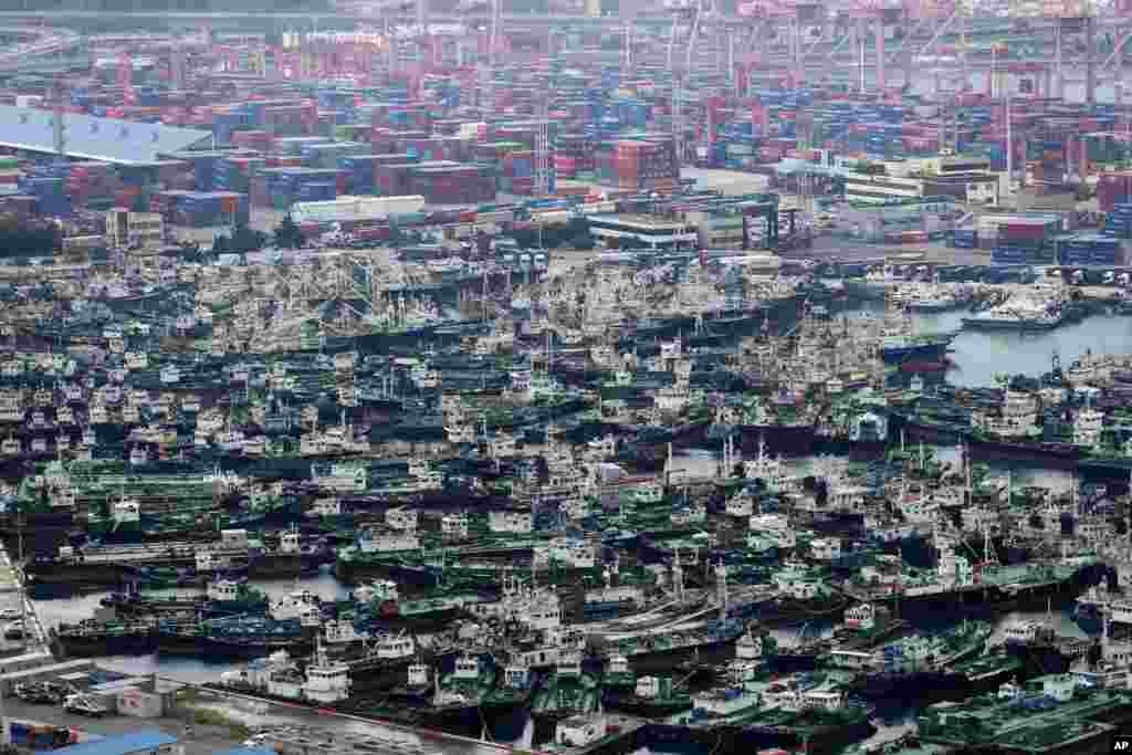 Ships are anchored at a port in Busan, South Korea. South Korea's weather agency said Typhoon Haishen was expected to skirt the Korean Peninsula's east coast on Monday with heavy rains and strong winds. 