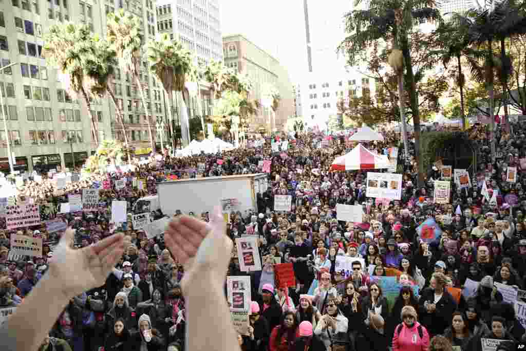 Protesters listen to a speaker as they gather for the Women's March against President Donald Trump, Jan. 21, 2017, in Los Angeles. (AP Photo/Jae C. Hong)