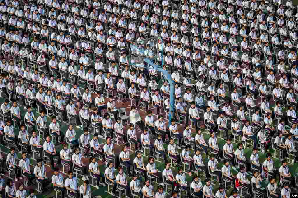 Students attend the 100th anniversary of the founding of Wuhan High School on the first day of the new semester in Wuhan in China's central Hubei province.