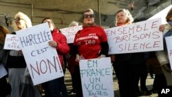 FILE - Demonstrators hold placards reading"Harassed it is no“, “In France a rape every 8 minutes“ and “Together let us break the silence", during a demonstration in Marseille, southern France, Sunday, Oct. 29, 2017. (AP Photo/Claude Paris)