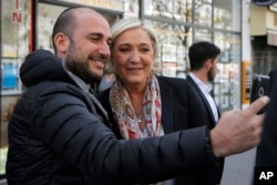 Marine Le Pen poses for a selfie Monday after getting a haircut in Paris.