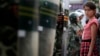 2009年7月9日一维吾尔族女孩在新疆省乌鲁木齐观看游行被防暴警察拦住。
