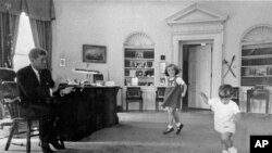 John Kennedy and his children in the Oval Office at the White House in 1962.
