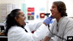 A doctor examines a patient. 