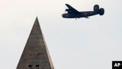 A B-24 Liberator, the bomber Tom Kelly flew in WW II, flies over Washington, D.C. Kelly's plane was shot down and crashed in the Pacific Ocean near Papua New Guinea in 1944.