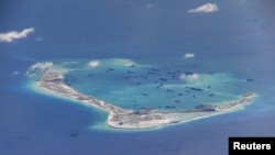 Chinese dredging vessels are purportedly seen in the waters around Mischief Reef in the disputed Spratly Islands in the South China Sea. This is a still image from video taken by a P-8A Poseidon surveillance aircraft provided by the United States Navy, May 21, 2015. (REUTERS/U.S. Navy/Handout via Reuters)