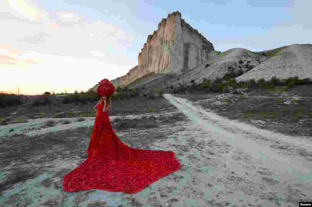 A model presents a creation during a Crimean Fashion Week show near the White Rock, also known as Aq-Qaya, outside Belogorsk, Sept. 13, 2020.