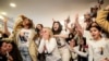Family members and supporters of Israeli hostage Agam Berger react as they watch a broadcast of Berger during her release, in Holon, Israel, Jan. 30, 2025. 