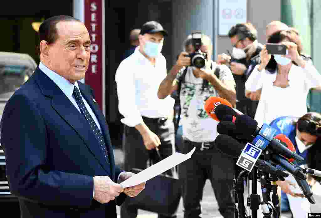 Former Italian Prime Minister Silvio Berlusconi speaks to the media as he leaves Milan's San Raffaele hospital, where he was being treated after testing positive for the COVID-19 and diagnosed with mild pneumonia, in Milan.