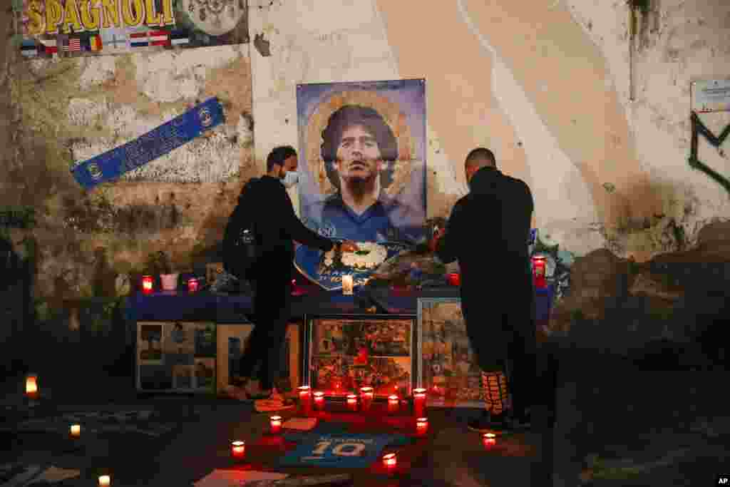 People gather and light candles to honor soccer legend Diego Maradona, at the popular &quot;Quartieri Spagnoli&quot; neighborhood, in Naples, Italy.